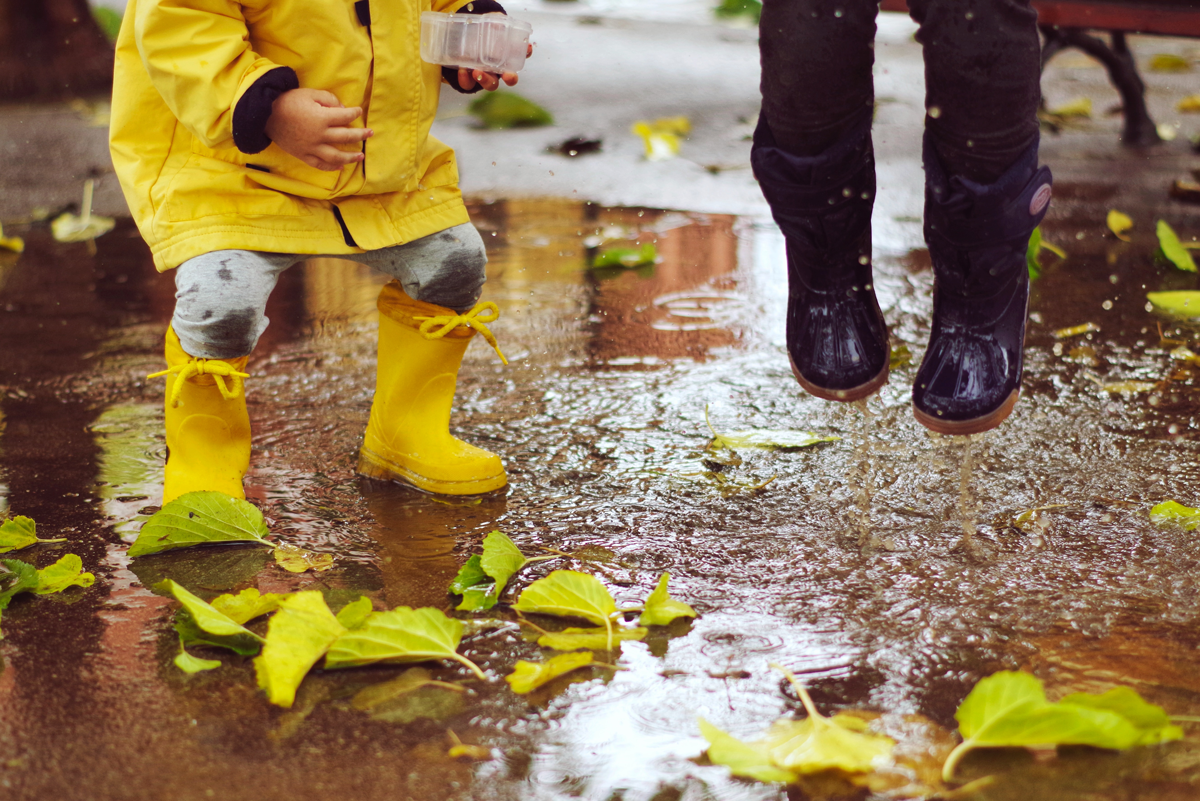 Kids jumping in a puddle