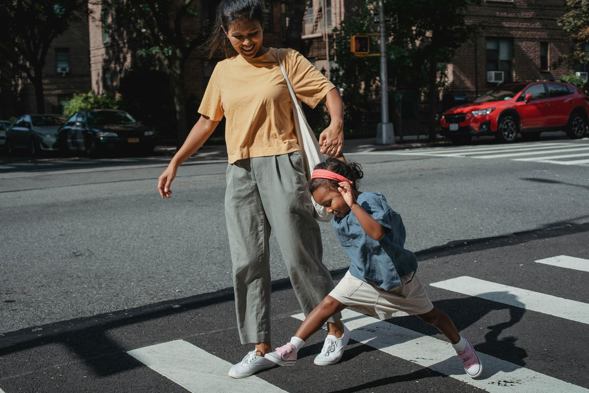 Mom and daughter walking on the crosswalk