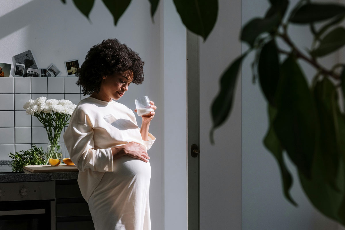 Pregnant woman holding a glass of milk