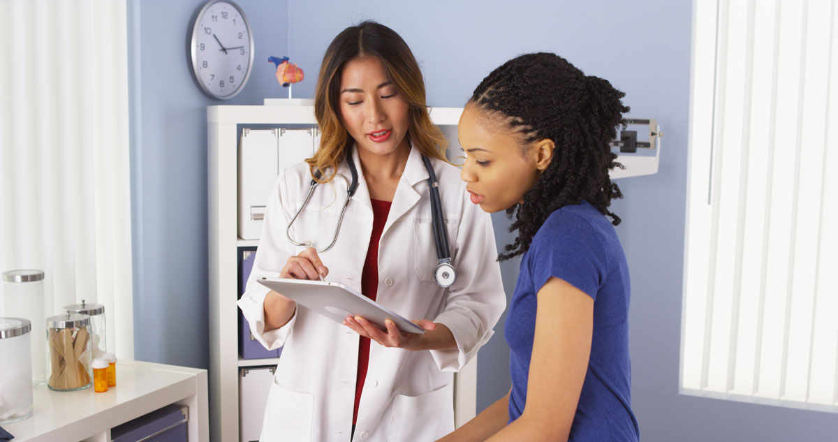 Woman speaking with healthcare practitioner